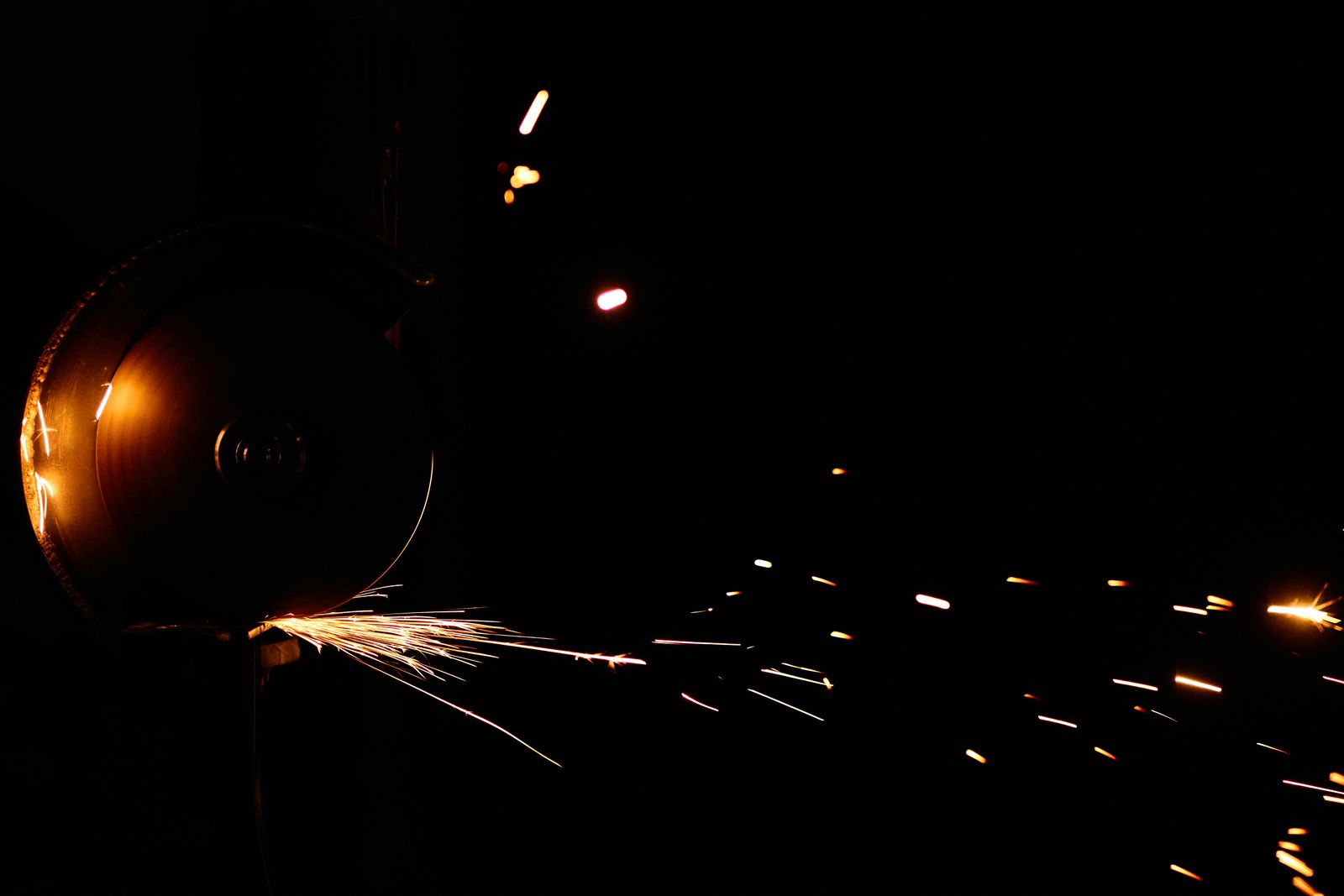 Angle grinder cutting stone with sparks