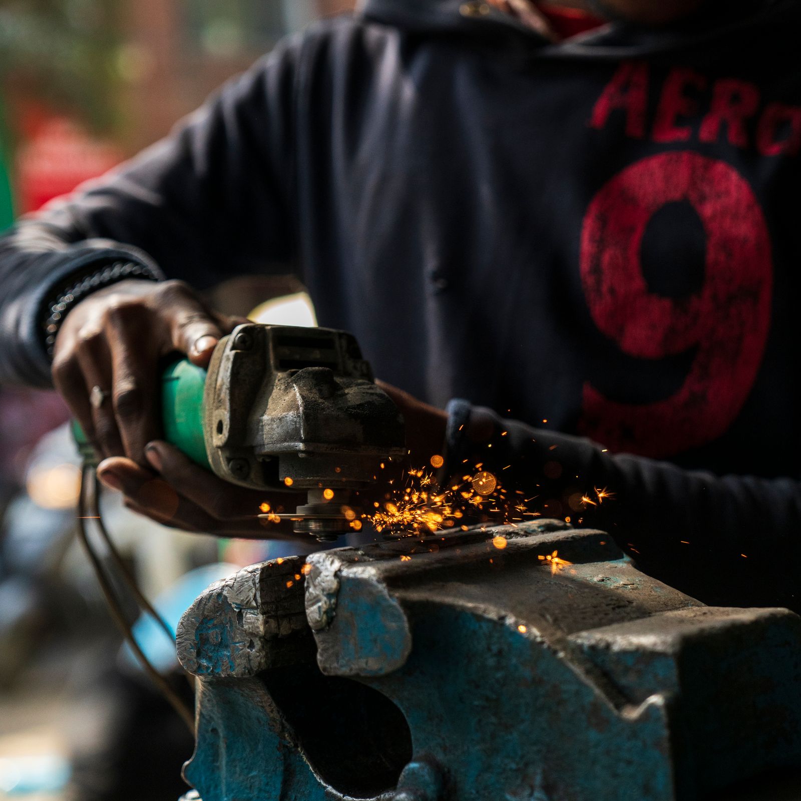 Craftsman working on metal and stone detail